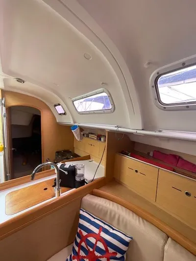  Yacht Photos Pics Interior of 2008 Beneteau First 40.7 sailboat with modern kitchen and cozy seating area.