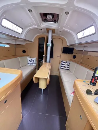  Yacht Photos Pics Interior of 2008 Beneteau First 40.7 sailboat with modern seating and wooden table.