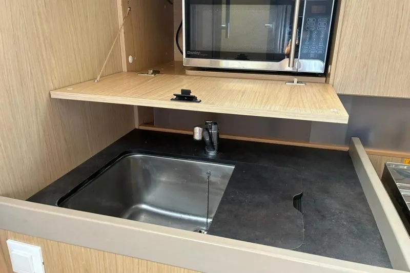 Mar III Yacht Photos Pics Modern kitchen in 2020 Beneteau Oceanis 41.1 yacht with sink and microwave.