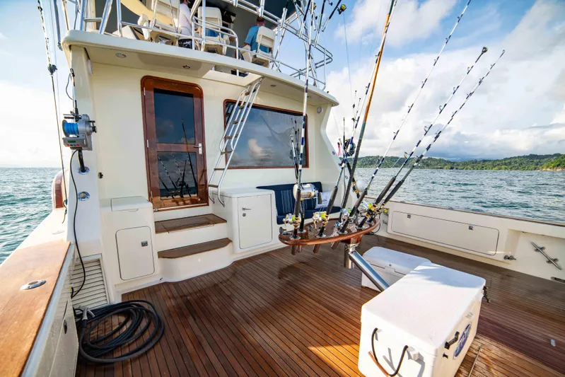 Crushing It Yacht Photos Pics 1996 Donzi 72 Custom Convertible yacht with fishing rods on deck.