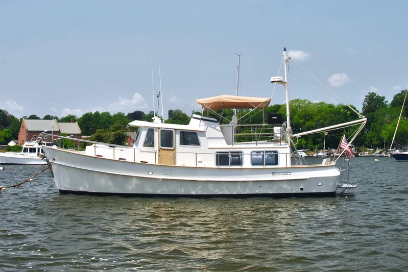 Valiant Yacht Photos Pics 2004 Transpacific Marine Eagle 40 yacht on a calm lake with trees in the background.