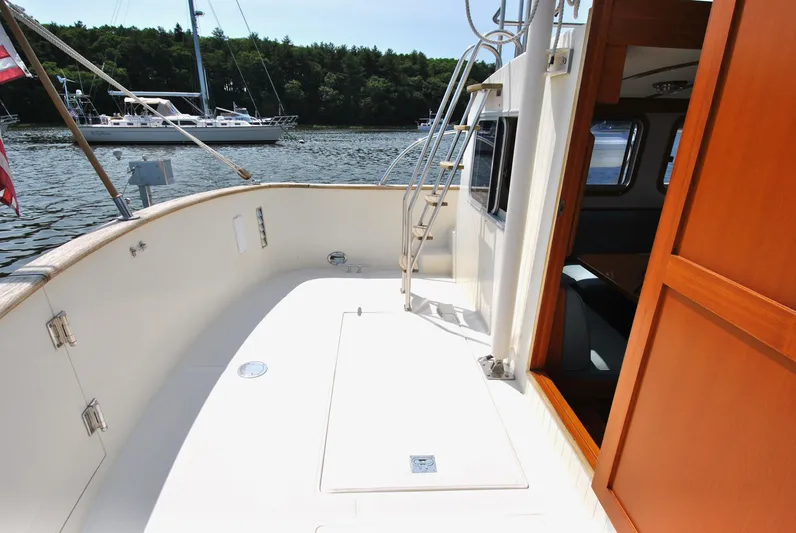 Valiant Yacht Photos Pics 2004 Transpacific Marine Eagle 40 yacht deck with open cabin door, docked near sailboats.