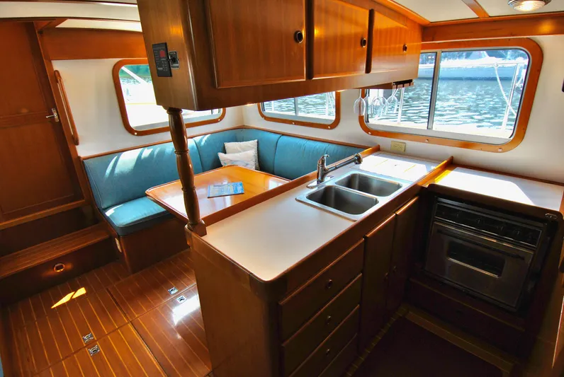 Valiant Yacht Photos Pics Interior of 2004 Transpacific Marine Eagle 40 yacht with kitchen and seating area.