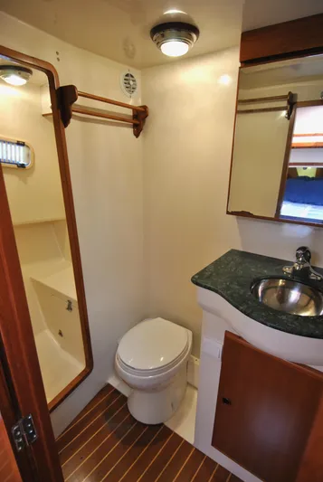 Valiant Yacht Photos Pics 2004 Transpacific Marine Eagle 40 yacht bathroom with toilet, sink, and wooden accents.