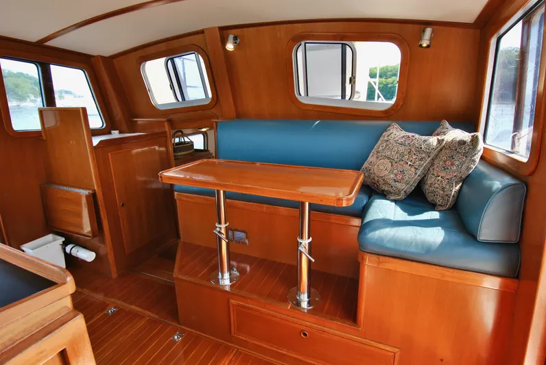 Valiant Yacht Photos Pics Luxurious interior of 2004 Transpacific Marine Eagle 40 yacht with wooden finish and blue seating.