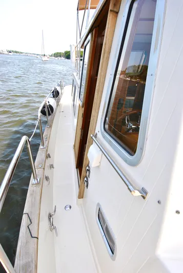 Valiant Yacht Photos Pics 2004 Transpacific Marine Eagle 40 yacht deck with railing, docked on calm water.