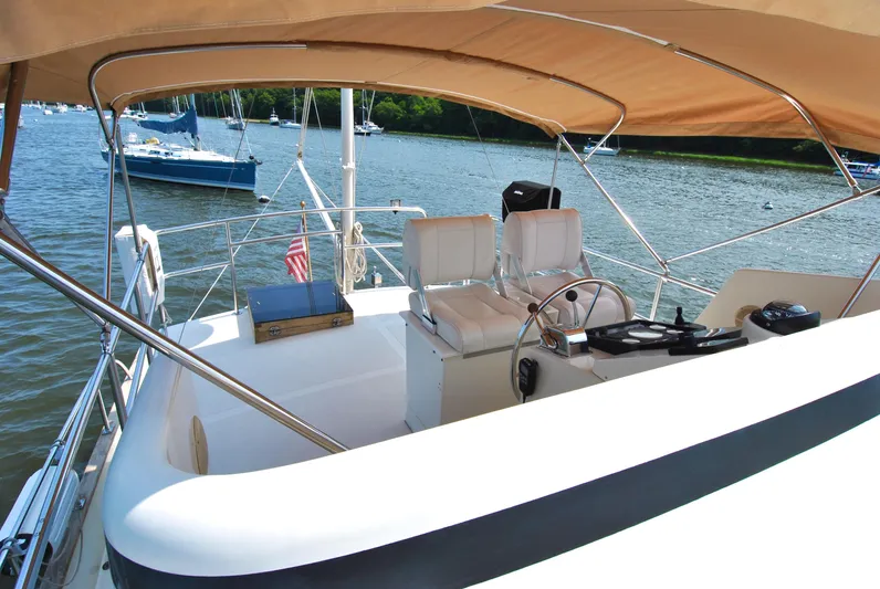 Valiant Yacht Photos Pics 2004 Transpacific Marine Eagle 40 yacht cockpit with helm, seating, and canopy on a sunny day.
