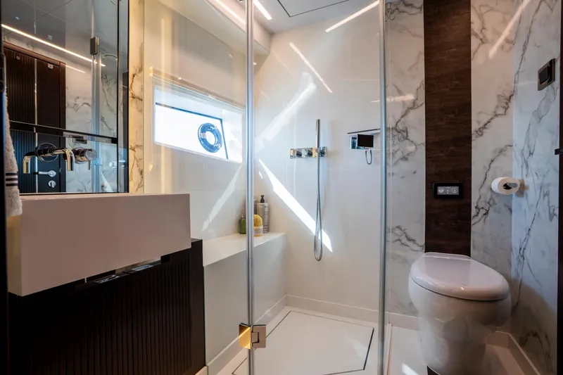 Masie Yacht Photos Pics Luxurious bathroom in 2023 Pearl 62 yacht with modern fixtures and marble accents.