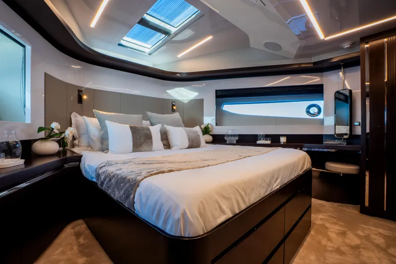 Masie Yacht Photos Pics Luxurious bedroom interior of 2023 Pearl 62 yacht with modern design and elegant lighting.