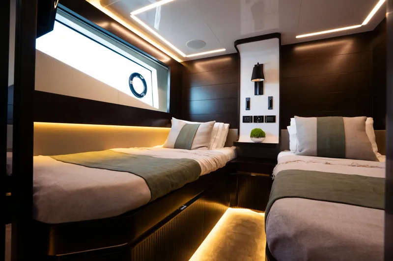 Masie Yacht Photos Pics Luxurious twin bedroom in 2023 Pearl 62 yacht with modern lighting and decor.