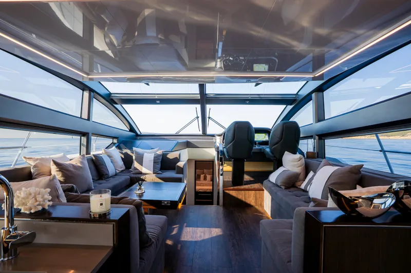 Masie Yacht Photos Pics Luxurious interior of 2023 Pearl 62 yacht with panoramic windows and elegant seating.