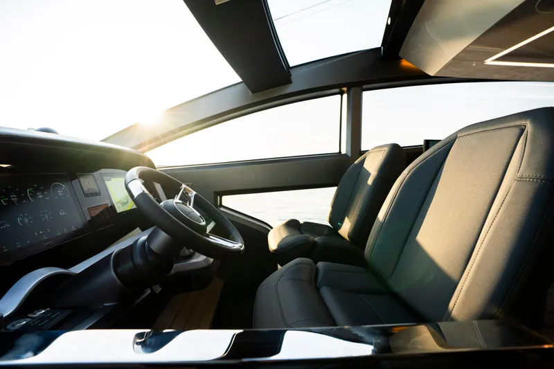 Masie Yacht Photos Pics Luxurious interior of 2023 Pearl 62 yacht with modern steering and seating.