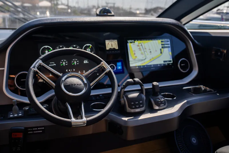 Masie Yacht Photos Pics 2023 Pearl 62 yacht dashboard with steering wheel and navigation display.
