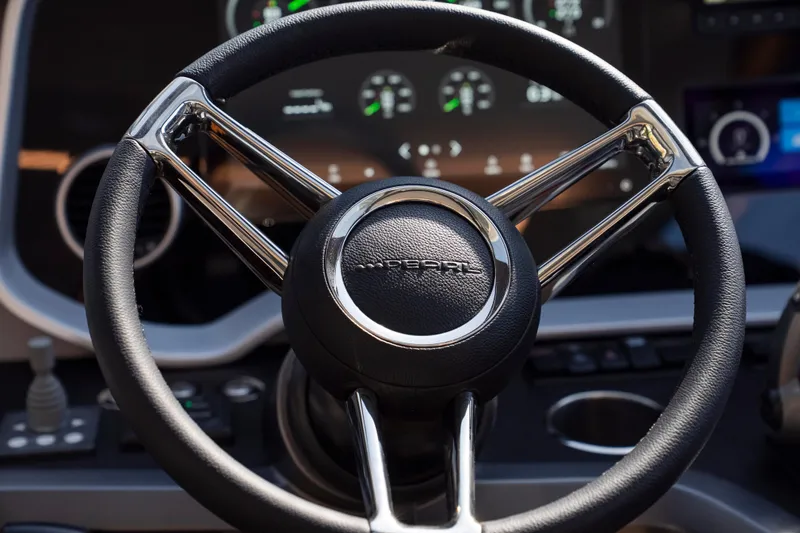 Masie Yacht Photos Pics Steering wheel of 2023 Pearl 62 with modern dashboard display.