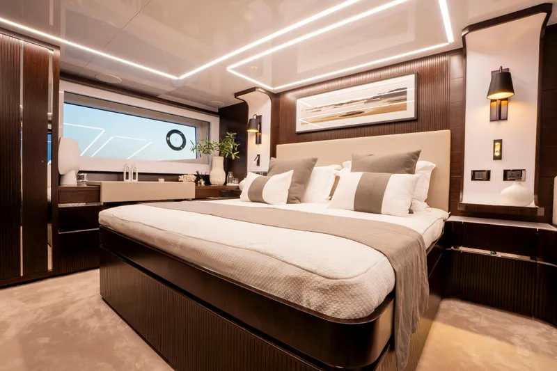 Masie Yacht Photos Pics Luxurious bedroom interior on 2023 Pearl 62 yacht, featuring modern design and elegant decor.
