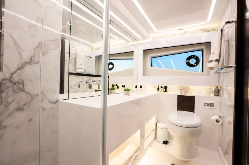 Masie Yacht Photos Pics Luxurious bathroom in 2023 Pearl 62 yacht with marble accents and modern fixtures.