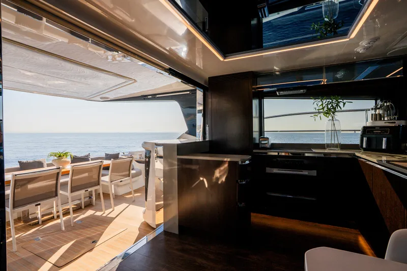 Masie Yacht Photos Pics Luxurious interior of 2023 Pearl 62 yacht with ocean view and elegant dining area.