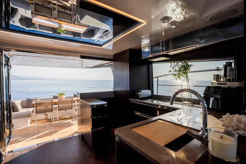 Masie Yacht Photos Pics Luxurious interior of 2023 Pearl 62 yacht with ocean view and modern kitchen amenities.