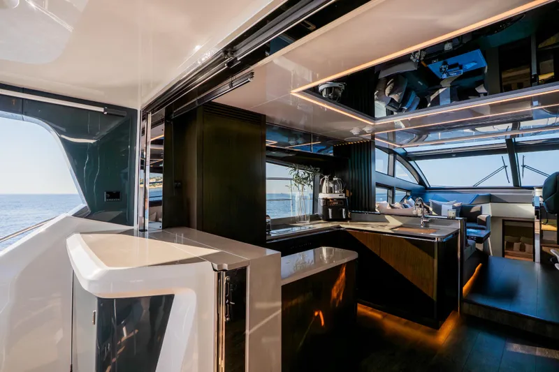 Masie Yacht Photos Pics Luxurious interior of 2023 Pearl 62 yacht with modern kitchen and ocean view.