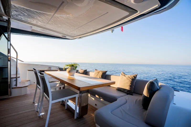 Masie Yacht Photos Pics Luxurious Pearl 62 yacht deck with seating, table, and ocean view, 2023 model.