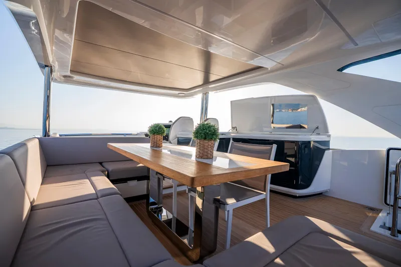 Masie Yacht Photos Pics Luxurious 2023 Pearl 62 yacht interior with elegant seating and dining area.
