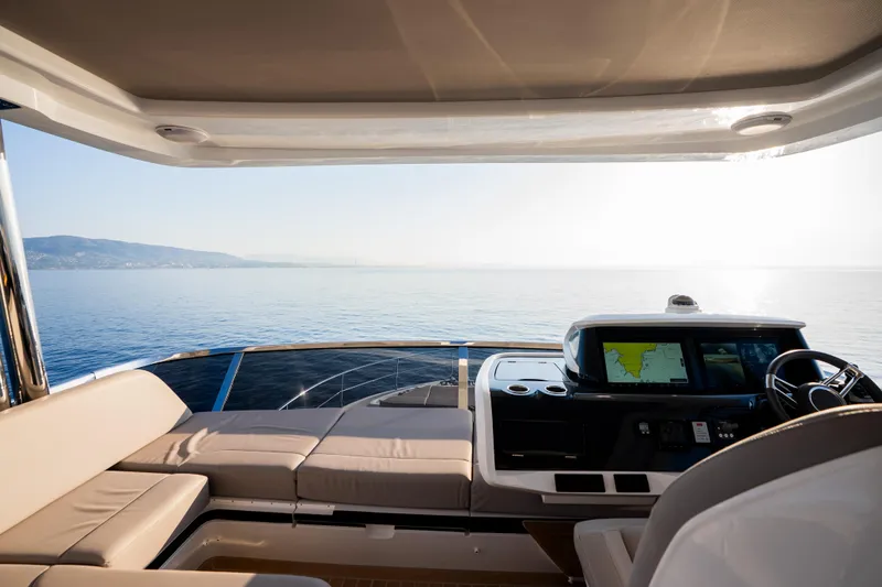 Masie Yacht Photos Pics Luxurious 2023 Pearl 62 yacht interior with navigation system, overlooking serene ocean view.