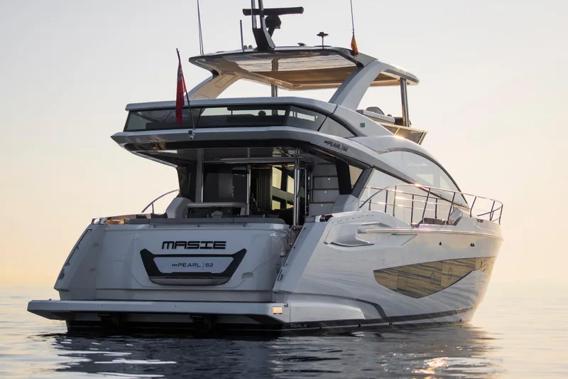 Masie Yacht Photos Pics Luxury Pearl 62 yacht, 2023 model, cruising at sunset on calm waters.