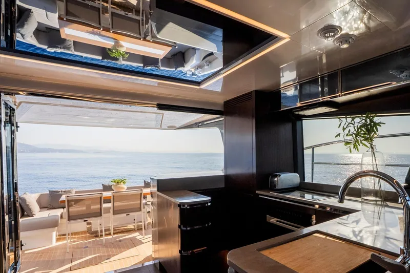 Masie Yacht Photos Pics Luxurious interior of 2023 Pearl 62 yacht with ocean view and modern kitchen.