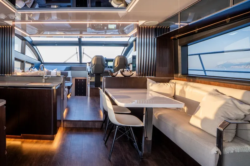 Masie Yacht Photos Pics Luxurious interior of 2023 Pearl 62 yacht with modern dining and seating area.