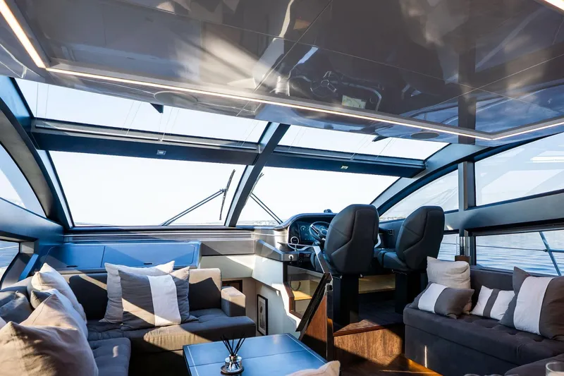 Masie Yacht Photos Pics Luxurious interior of 2023 Pearl 62 yacht with modern seating and panoramic windows.