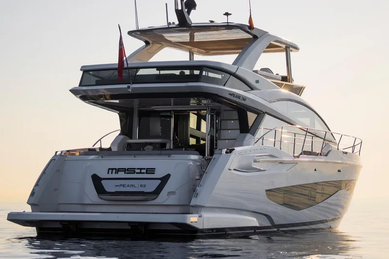 Masie Yacht Photos Pics Luxurious 2023 Pearl 62 yacht on calm waters at sunset.