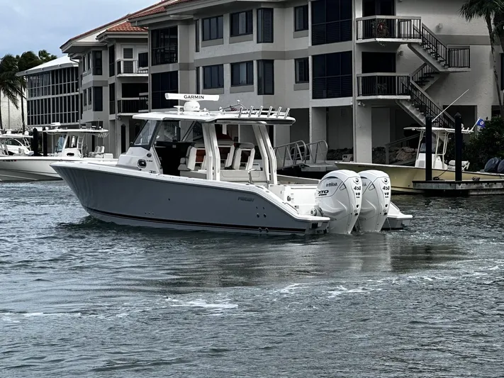  Yacht Photos Pics 2024 Pursuit 358 SPORT boat with triple Yamaha engines in a marina setting.