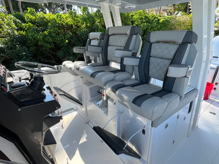  Yacht Photos Pics 2024 Pursuit 358 SPORT boat interior with luxurious seating and modern steering console.