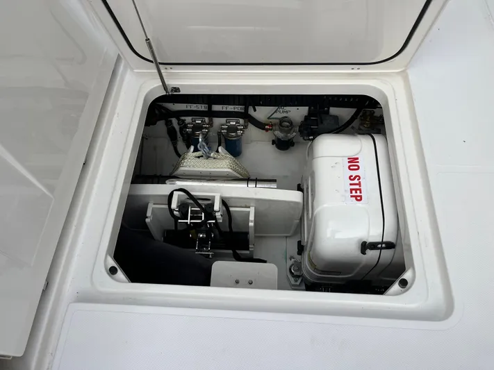  Yacht Photos Pics Engine compartment of 2024 Pursuit 358 SPORT boat, featuring "NO STEP" warning label.