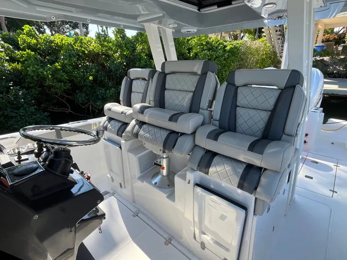 Yacht Photos Pics 2024 Pursuit 358 SPORT boat interior with luxurious seating and modern steering console.