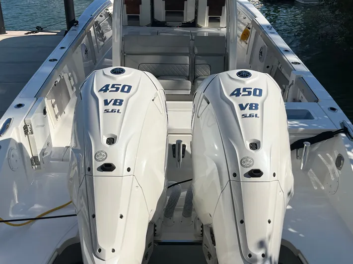  Yacht Photos Pics 2024 Pursuit 358 SPORT boat with dual 450 V8 engines, docked by the water.