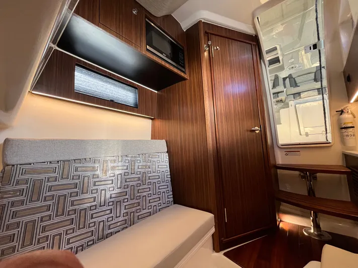  Yacht Photos Pics 2024 Pursuit 358 SPORT cabin interior with modern wood finish and geometric upholstery.