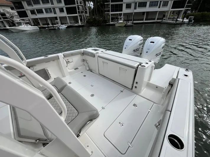  Yacht Photos Pics 2024 Pursuit 358 SPORT boat with dual engines, docked near waterfront buildings.