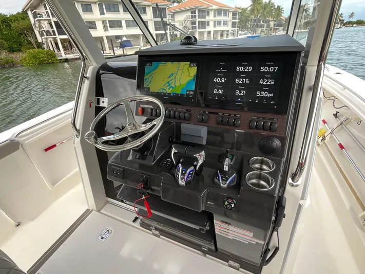  Yacht Photos Pics 2024 Pursuit 358 SPORT boat dashboard with navigation screens and controls.