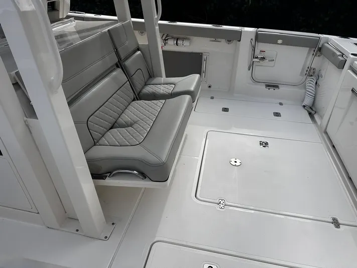  Yacht Photos Pics 2024 Pursuit 358 SPORT boat interior with gray seating and spacious deck layout.