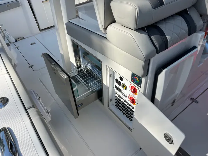  Yacht Photos Pics 2024 Pursuit 358 SPORT boat interior with open storage and control panel.