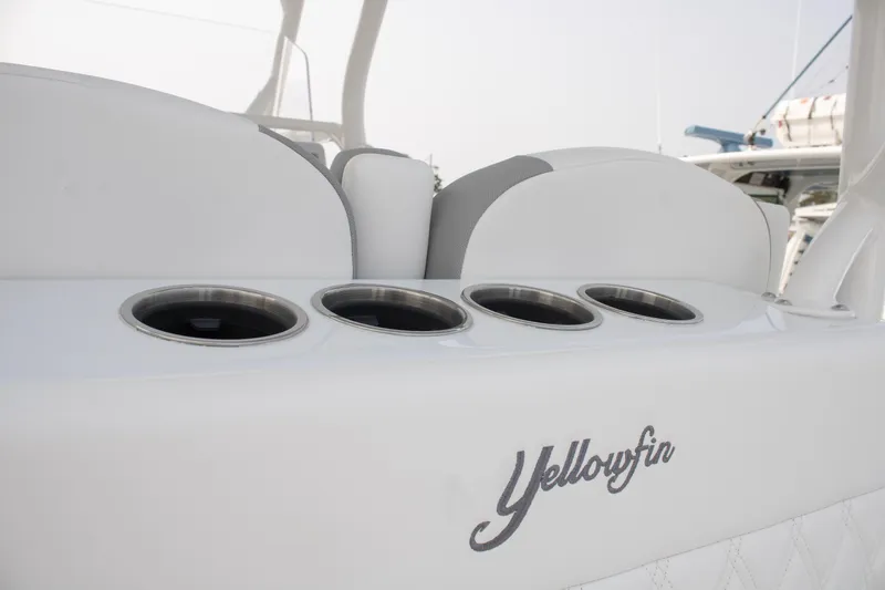  Yacht Photos Pics 2025 Yellowfin 32 Offshore boat interior with cup holders and logo detail.