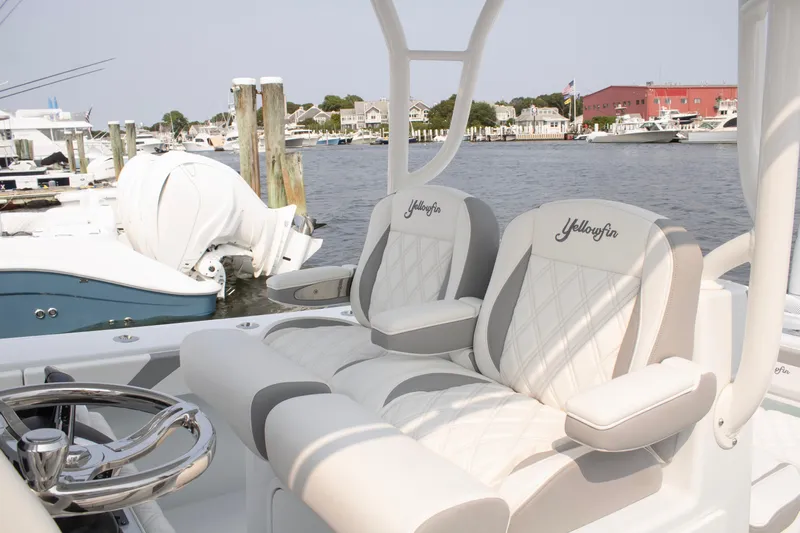  Yacht Photos Pics 2025 Yellowfin 32 Offshore boat interior with luxurious seating at a marina.