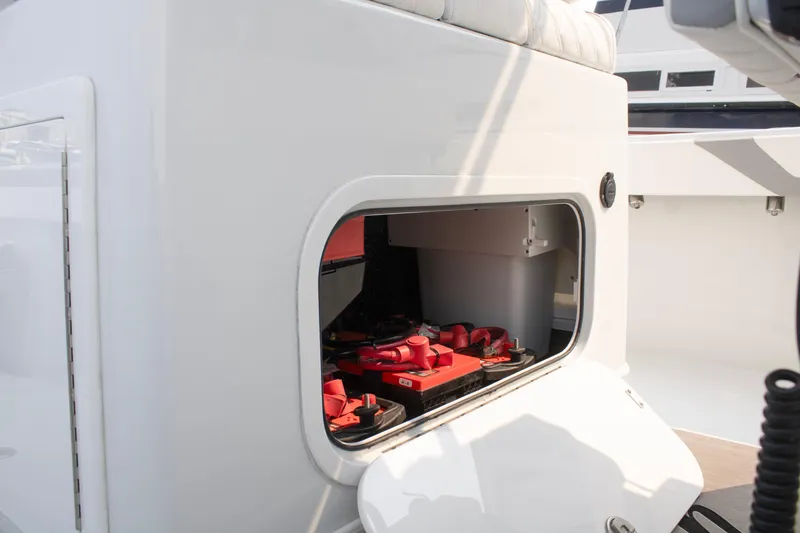  Yacht Photos Pics 2025 Yellowfin 32 Offshore boat battery compartment with red batteries visible.