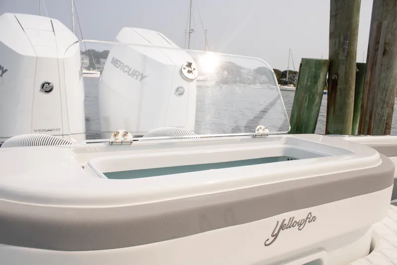  Yacht Photos Pics 2025 Yellowfin 32 Offshore boat with Mercury engines, docked by wooden posts.