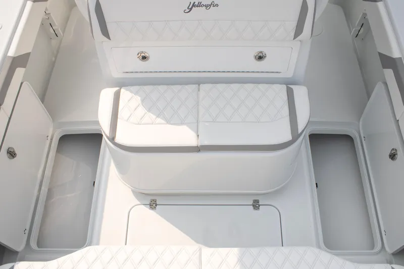  Yacht Photos Pics 2025 Yellowfin 32 Offshore boat interior with white cushioned seating and storage compartments.