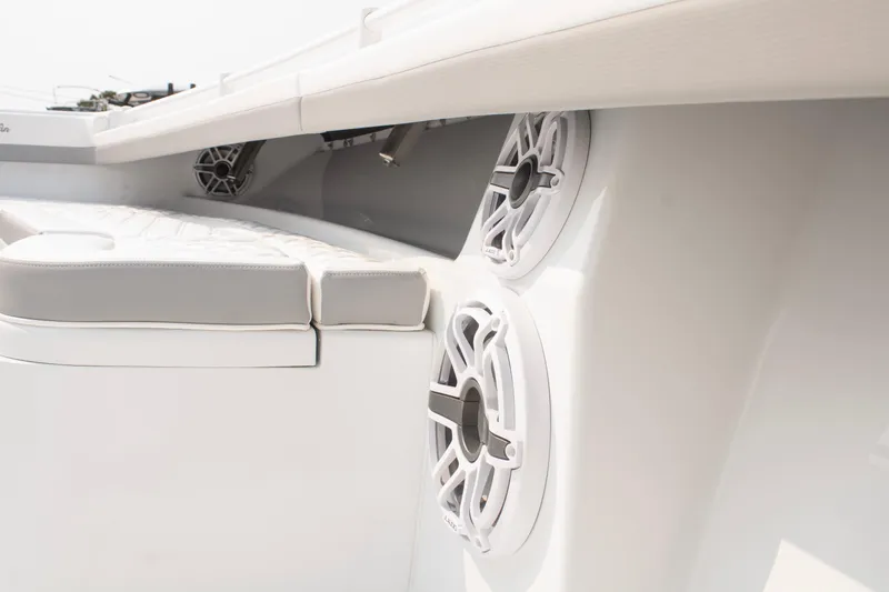  Yacht Photos Pics 2025 Yellowfin 32 Offshore boat interior with speakers and cushioned seating.