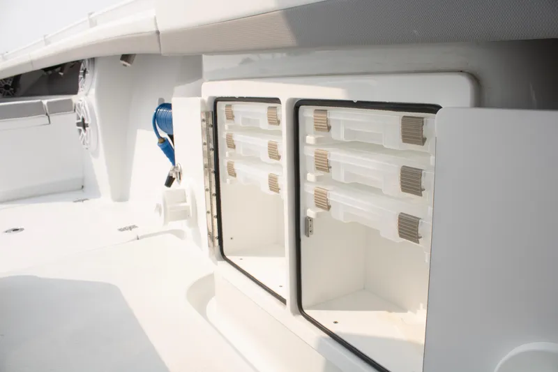  Yacht Photos Pics 2025 Yellowfin 32 Offshore boat storage compartment with organized tackle boxes.