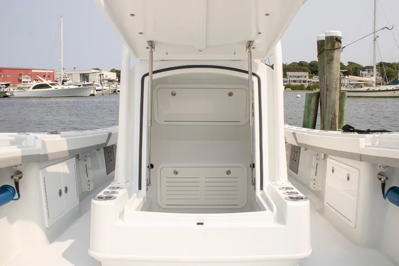  Yacht Photos Pics 2025 Yellowfin 32 Offshore boat interior, featuring storage compartments and sleek design at a marina.