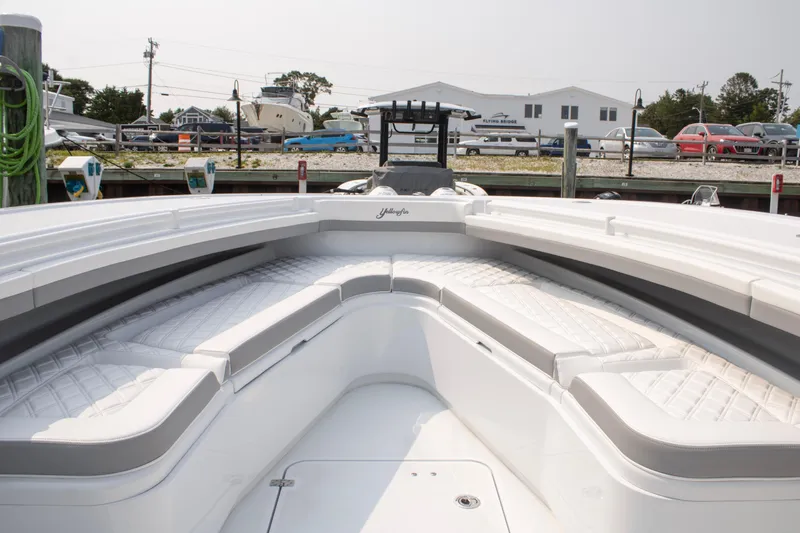  Yacht Photos Pics 2025 Yellowfin 32 Offshore boat interior with cushioned seating at dock.